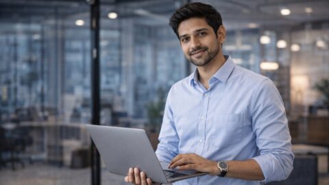 Confident Professional Using Laptop in Modern Office