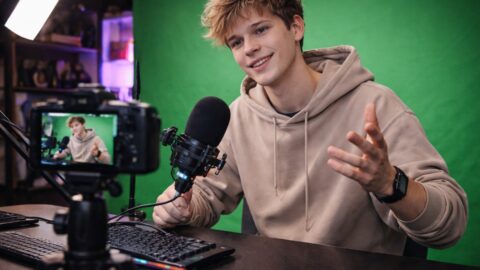 Young Man Recording Video at Desk